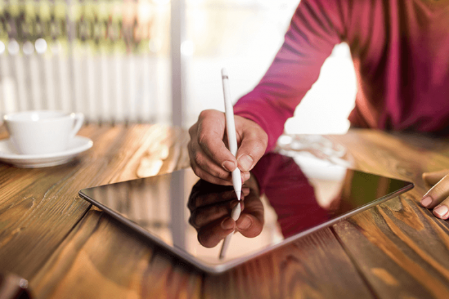 Man writing on tablet