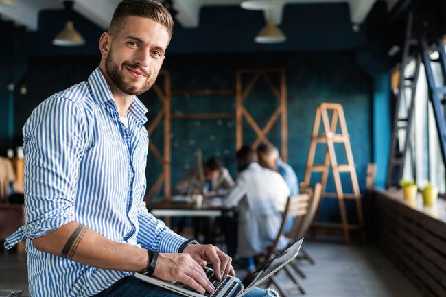 Man smiling and using computer