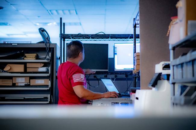 Man using laptop and computer