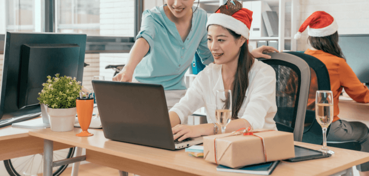 office workers wearing holiday hats