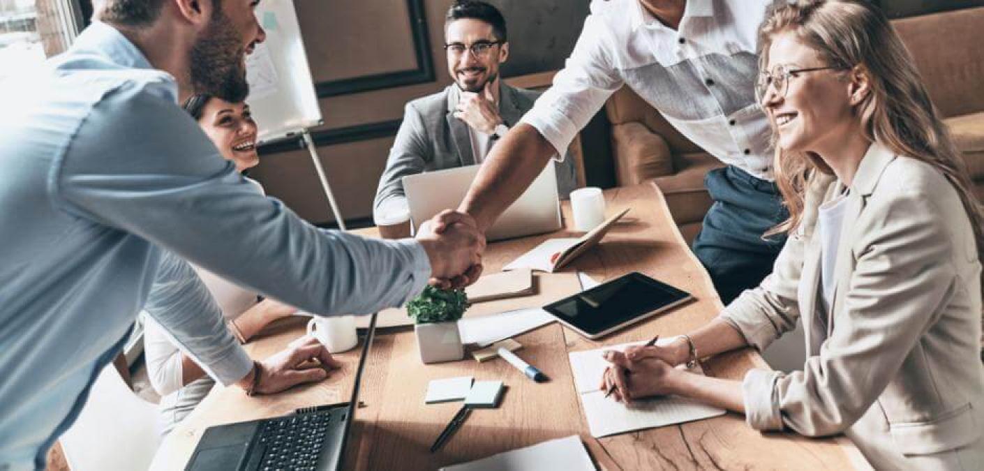 People shaking hands in a meeting